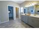 Elegant bathroom with double vanity, gray cabinets, and a walk-in shower at 15235 S Country Club Dr, Arizona City, AZ 85123