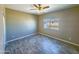 Bright bedroom featuring wood-look flooring and ceiling fan at 15235 S Country Club Dr, Arizona City, AZ 85123