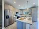 Modern kitchen with gray cabinets, stainless steel appliances, and a large island at 15235 S Country Club Dr, Arizona City, AZ 85123