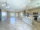 Open concept living room and kitchen with tile floors and lots of natural light at 15235 S Country Club Dr, Arizona City, AZ 85123