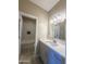 Modern bathroom with white vanity, marble shower, and gray floor tiles at 15245 S Country Club Dr, Arizona City, AZ 85123