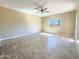 Spacious living room with wood-look tile floor and ceiling fan at 15245 S Country Club Dr, Arizona City, AZ 85123