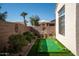 Landscaped backyard with putting green and a patio area at 15437 W Domingo Ln, Sun City West, AZ 85375