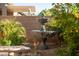 Serene backyard featuring a lovely fountain and lush landscaping at 15437 W Domingo Ln, Sun City West, AZ 85375