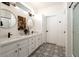 Bright bathroom featuring a double vanity and patterned floor tile at 15437 W Domingo Ln, Sun City West, AZ 85375