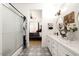 Elegant bathroom with a walk-in shower, double vanity, and patterned floor tile at 15437 W Domingo Ln, Sun City West, AZ 85375