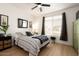 Bedroom with striped bedding, a large window, and a green armoire at 15437 W Domingo Ln, Sun City West, AZ 85375