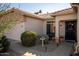 Front entry with a black security door, bird bath, and landscaping at 15437 W Domingo Ln, Sun City West, AZ 85375