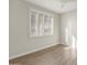 Well-lit bedroom with plantation shutters and wood floors at 15513 W Coral Pointe Dr, Surprise, AZ 85374