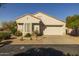 Single-story home with a two-car garage and desert landscaping at 15513 W Coral Pointe Dr, Surprise, AZ 85374