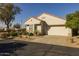 Single-story home with a two-car garage and mature landscaping at 15513 W Coral Pointe Dr, Surprise, AZ 85374