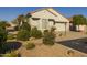 Single-story home with a two-car garage and well-maintained landscaping at 15513 W Coral Pointe Dr, Surprise, AZ 85374