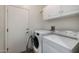 Laundry room with washer, dryer, and storage cabinets at 15513 W Coral Pointe Dr, Surprise, AZ 85374