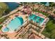 Resort-style pool, spa, and clubhouse with palm trees at 15513 W Coral Pointe Dr, Surprise, AZ 85374