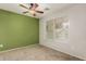 Bedroom with ceiling fan and large window at 15720 W Crocus Dr, Surprise, AZ 85379