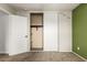 Bedroom with double door closet and green accent wall at 15720 W Crocus Dr, Surprise, AZ 85379