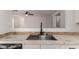 Modern kitchen sink and countertops with tile backsplash at 15720 W Crocus Dr, Surprise, AZ 85379