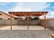 Wooden patio cover in backyard providing shade at 15720 W Crocus Dr, Surprise, AZ 85379