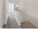 Upstairs hallway with carpet and access to bedrooms at 1601 N Saba St # 306, Chandler, AZ 85225