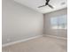 Bright bedroom with ceiling fan and large window at 17183 W San Marcos St, Surprise, AZ 85388