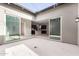 View of kitchen through open courtyard with glass doors at 17183 W San Marcos St, Surprise, AZ 85388