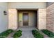 Inviting front entry with stone accents and a dark-stained door at 17183 W San Marcos St, Surprise, AZ 85388