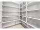 Large walk-in pantry with ample shelving for storage at 17183 W San Marcos St, Surprise, AZ 85388