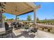 Covered patio with seating overlooking golf course at 17183 W San Marcos St, Surprise, AZ 85388