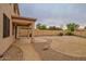 Landscaped backyard with covered patio and walkway at 17427 W Rock Wren Ct, Goodyear, AZ 85338