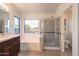 Main bathroom with soaking tub and shower stall at 17427 W Rock Wren Ct, Goodyear, AZ 85338