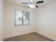 Well-lit bedroom featuring ceiling fan and carpet at 17427 W Rock Wren Ct, Goodyear, AZ 85338