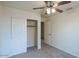 Bright bedroom with ceiling fan and closet at 17427 W Rock Wren Ct, Goodyear, AZ 85338