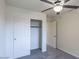 Bedroom with ceiling fan, large closet, and carpeting at 17427 W Rock Wren Ct, Goodyear, AZ 85338