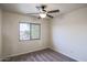 Bright bedroom with ceiling fan and plush carpeting at 17427 W Rock Wren Ct, Goodyear, AZ 85338