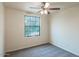 Spacious bedroom with large window and ceiling fan at 17427 W Rock Wren Ct, Goodyear, AZ 85338