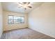 Bright bedroom with carpeted floor and ceiling fan at 17427 W Rock Wren Ct, Goodyear, AZ 85338