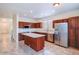 Kitchen with island, stainless steel appliances, and wood cabinets at 17427 W Rock Wren Ct, Goodyear, AZ 85338