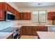 Kitchen features stainless steel appliances and wood cabinets at 17427 W Rock Wren Ct, Goodyear, AZ 85338