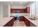 Modern kitchen with stainless steel appliances and light countertops at 17427 W Rock Wren Ct, Goodyear, AZ 85338