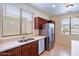 Kitchen with stainless steel appliances and double sink at 17427 W Rock Wren Ct, Goodyear, AZ 85338