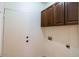 Laundry room with upper cabinets and door at 17427 W Rock Wren Ct, Goodyear, AZ 85338