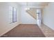 Spacious living room with stairs, carpet, and tile flooring at 17427 W Rock Wren Ct, Goodyear, AZ 85338