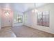 Bright living room with tile and carpet flooring, and neutral colors at 17427 W Rock Wren Ct, Goodyear, AZ 85338