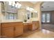 Double vanity bathroom with light wood cabinets and large mirror at 18009 W Denton Ave, Litchfield Park, AZ 85340