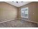 Bright bedroom with carpeted floors and window with shutters at 18009 W Denton Ave, Litchfield Park, AZ 85340