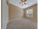 Neutral bedroom with carpet, ceiling fan, plantation shuttered windows, and a closet at 18009 W Denton Ave, Litchfield Park, AZ 85340