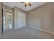 Bedroom with neutral carpet, a ceiling fan, and a closet with sliding doors at 18009 W Denton Ave, Litchfield Park, AZ 85340