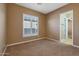 Bedroom with window shutters and access to bathroom at 18009 W Denton Ave, Litchfield Park, AZ 85340