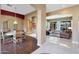 Open dining area adjacent to living room with wood floors at 18009 W Denton Ave, Litchfield Park, AZ 85340