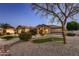 House exterior at dusk with landscaping and a putting green at 18009 W Denton Ave, Litchfield Park, AZ 85340